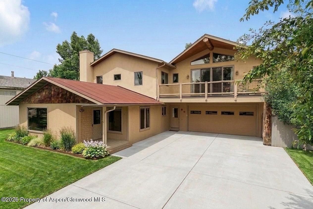 Architectural front elevation of 81 Cheyenne Avenue, with twin gables, copper-toned standing-seam roof entry, cedar-shake skirt, and stucco upper story under cottonwood canopy